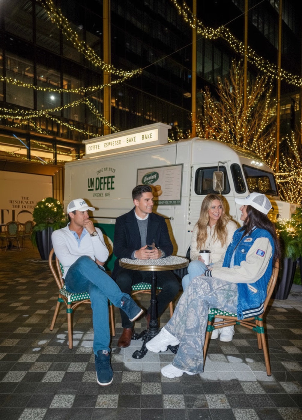 Four friends talking together at a cafe
